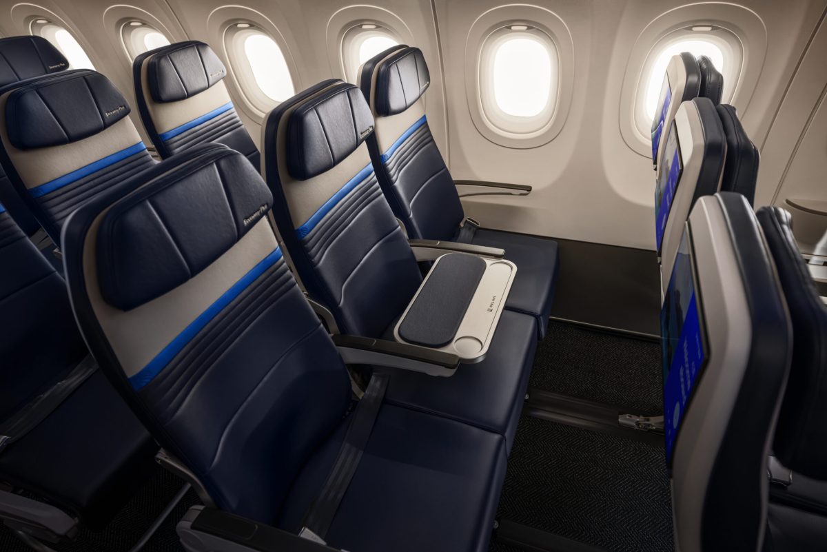 United Airlines A321XLR cabin with navy seats and blue accents, middle seat replaced by shared workspace table