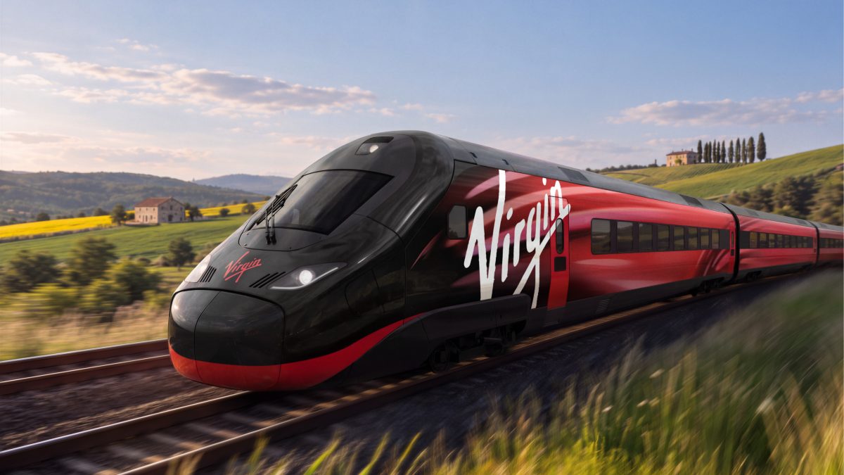 Virgin high-speed train speeding through a scenic countryside landscape.