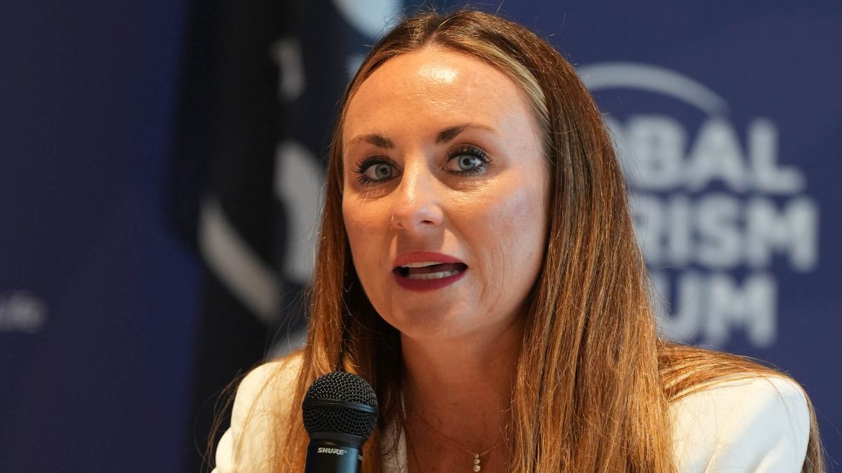 Woman speaking at microphone during business conference event