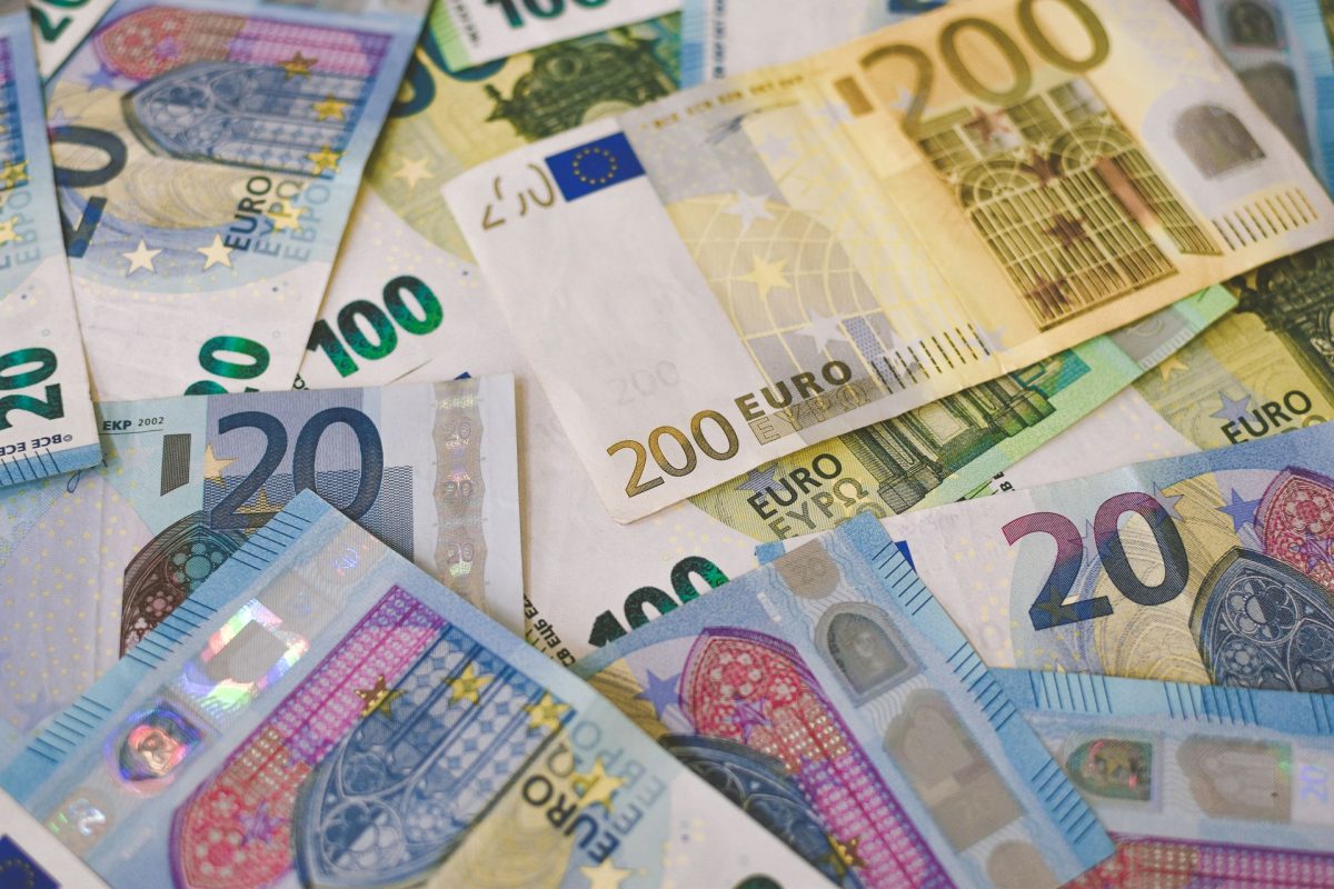 Euro banknotes in various denominations scattered across a surface