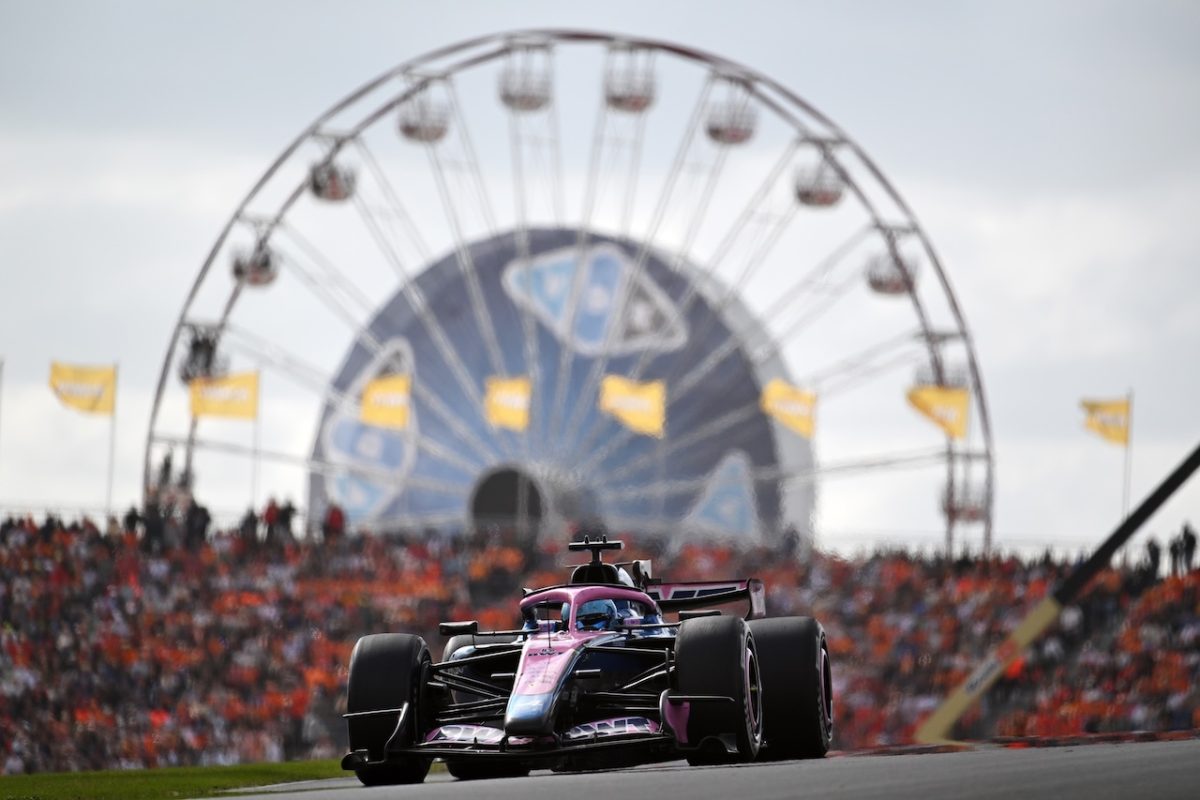 Formula 1 car racing at Zandvoort circuit with Ferris wheel backdrop